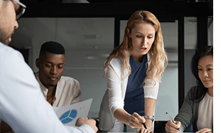 Business women and men in an office working on finances.