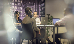 Group of business people talking about financing around a conference table.