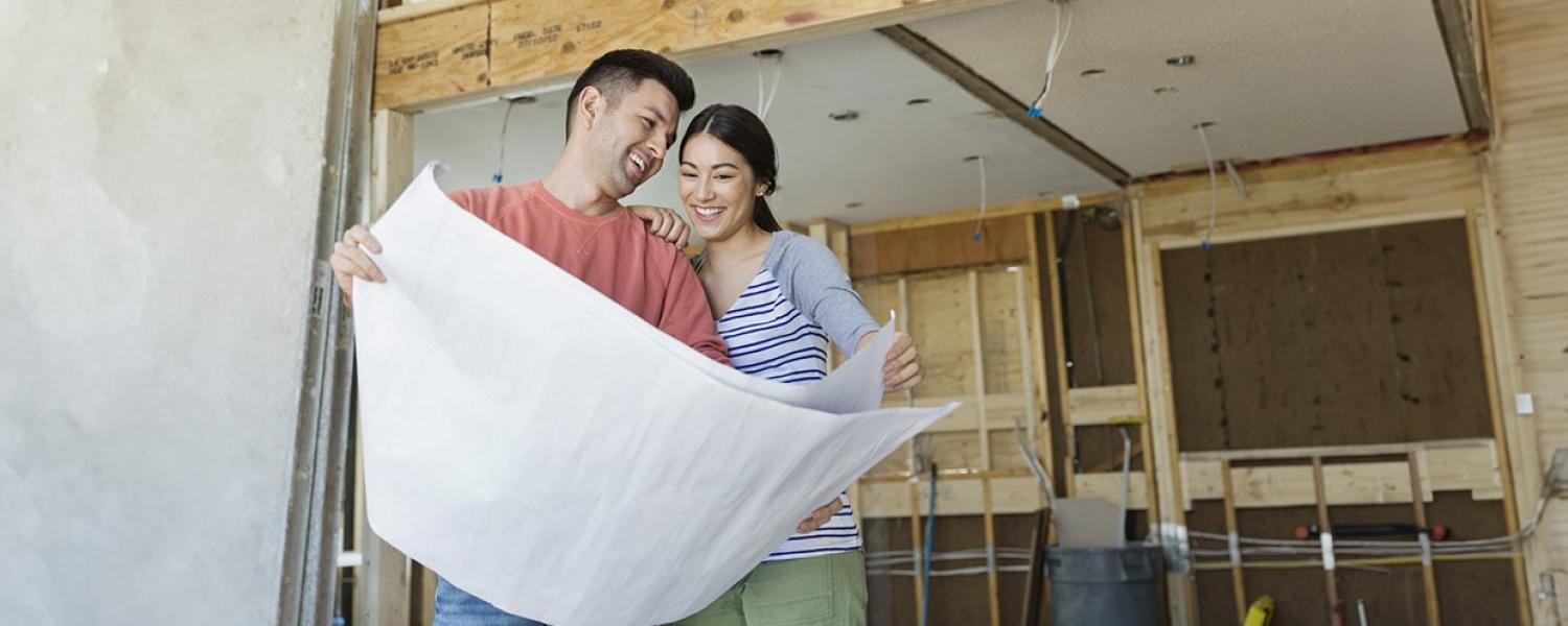 Couple looking at plans for their addition. Sandy Spring Bank HELOC